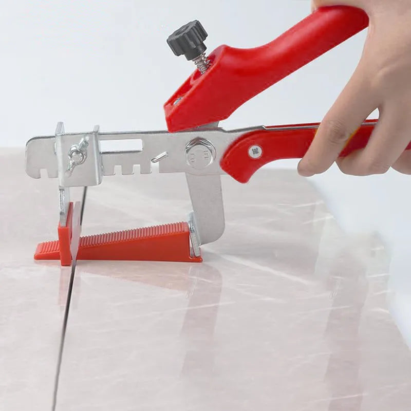 Red tile leveler aid with PVC handle and stainless steel clip measuring 23 by 11.5 centimetres