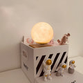 Maglev floating moon and earth night light with three astronaut figurines and soft LED glow.
