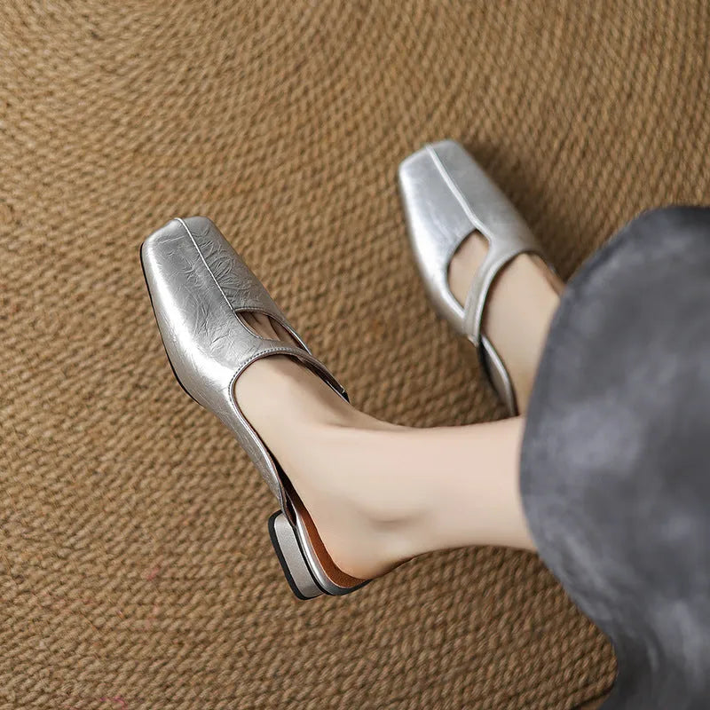 British style square head outdoor slippers in black, beige and silver colours with a low heel and rubber sole.