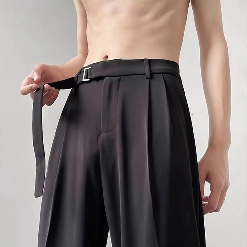 A pair of thin, black, loose-fit wide leg trousers with a straight leg opening, laid flat.