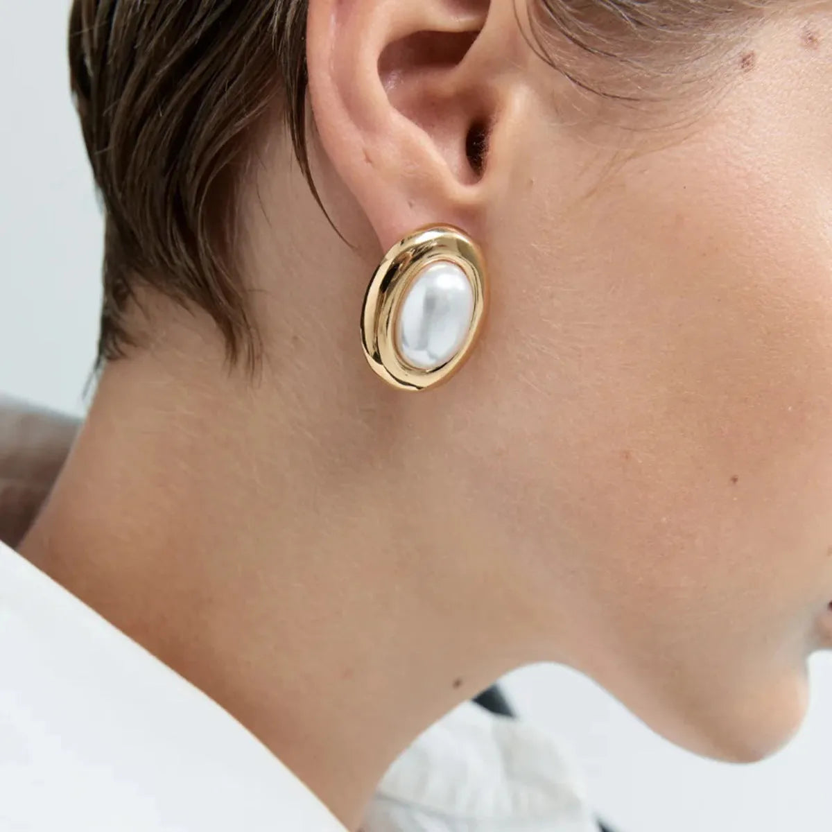 Close-up of stainless steel vintage pearl ear studs for women with a non-fade electroplated finish.