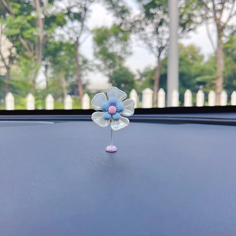 Colourful plastic swing car decoration measuring 5cm tall