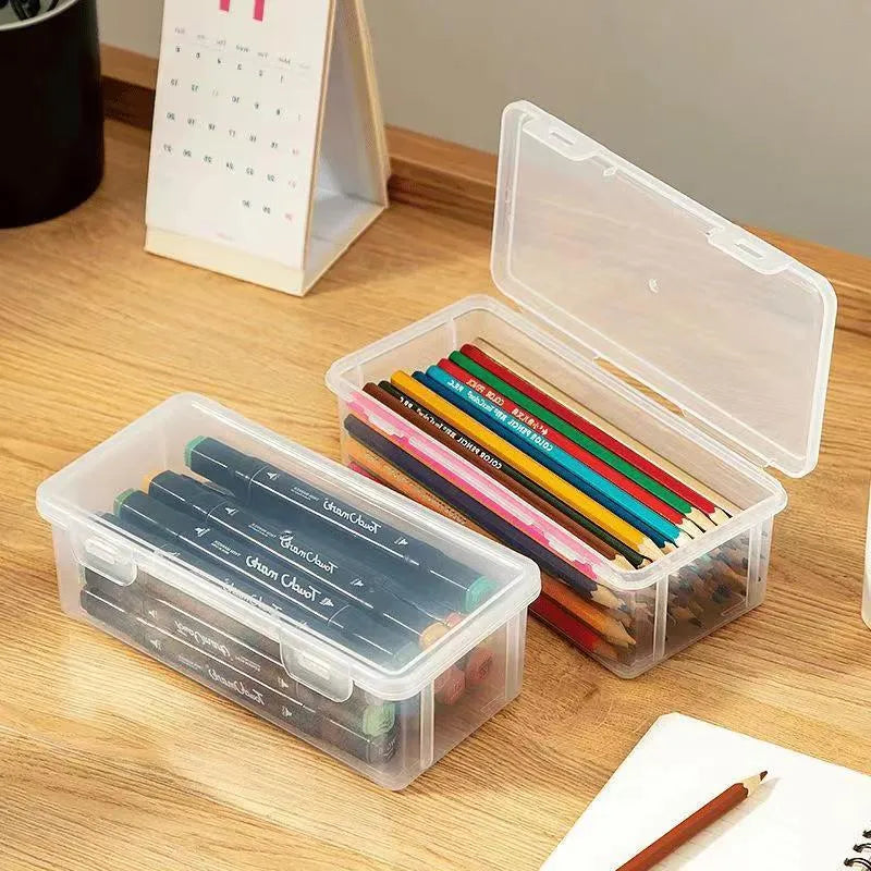 Clear plastic pencil storage box with large capacity for organising stationery and children's art supplies.