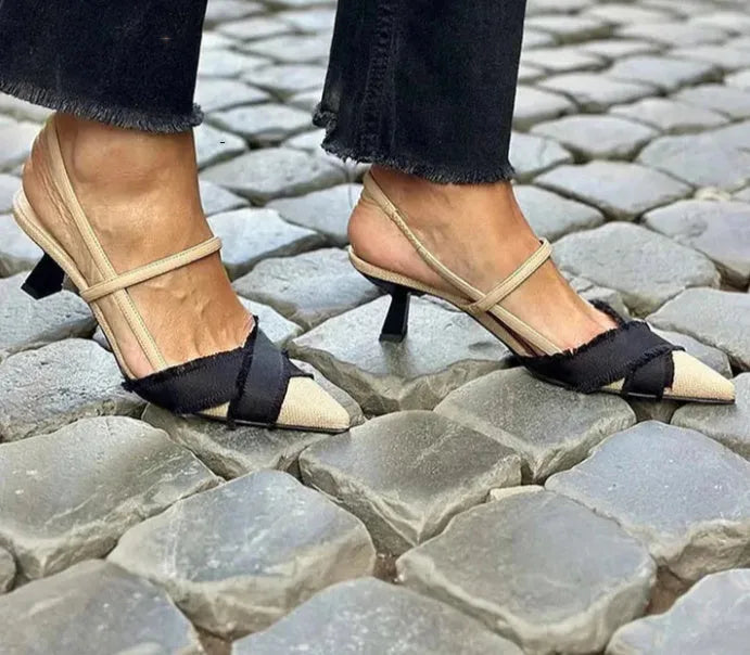 Apricot and black colour block women's sandals with a stiletto heel and buckle fastening.