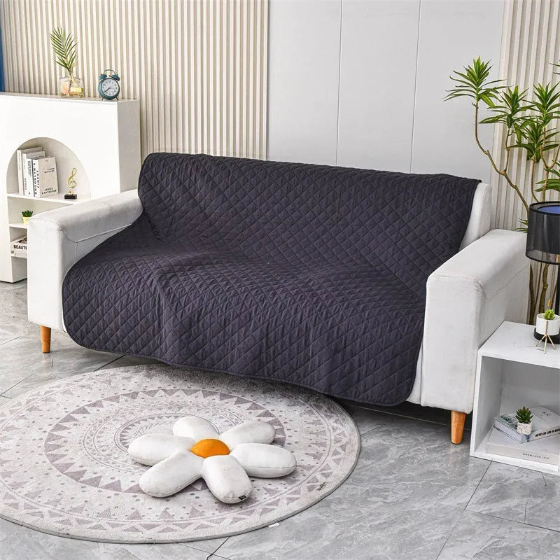 Waterproof reversible dog blanket on a sofa, showing two colour sides, with size chart for nine options.