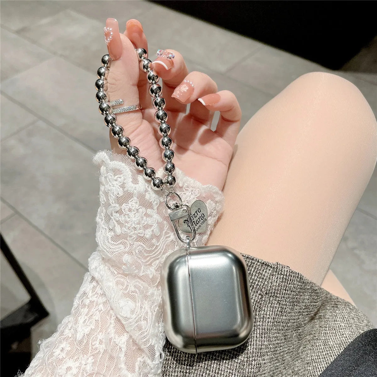 Matte plating protective case for AirPods with integrated bracelet showing electroplated finish