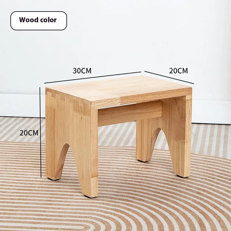 Solid wood household changing stool with a distressed finish and bracket structure.