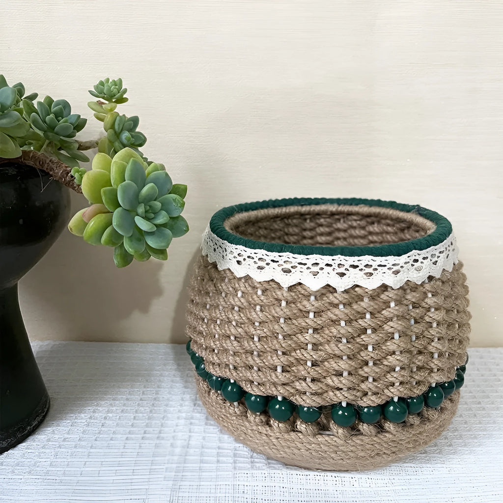 Rattan hand woven cylinder storage basket in green on desktop holding snacks and keys