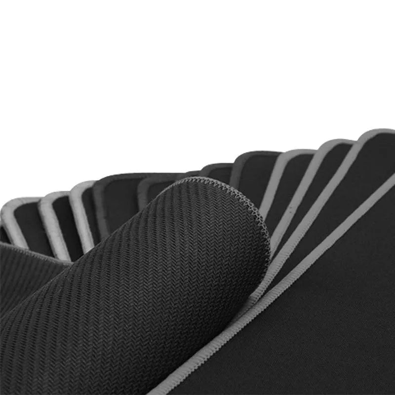 Solid colour black extra long overlock mouse pad on desk with keyboard and mouse