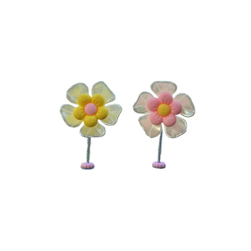 Colourful plastic swing car decoration measuring 5cm tall