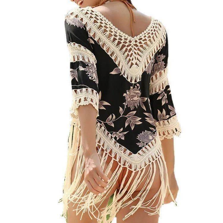 Apricot coloured V-neck sun protection shirt with hollow-out sleeves on a hanger.