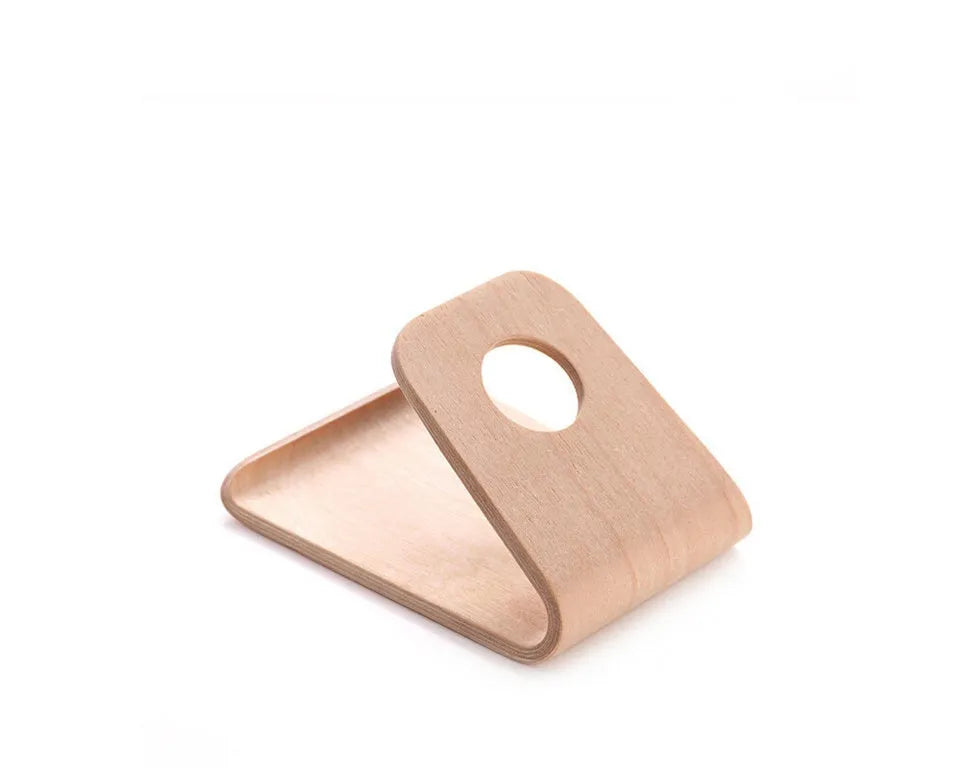 Wooden iPhone stand in walnut finish on a desk holding a mobile phone.