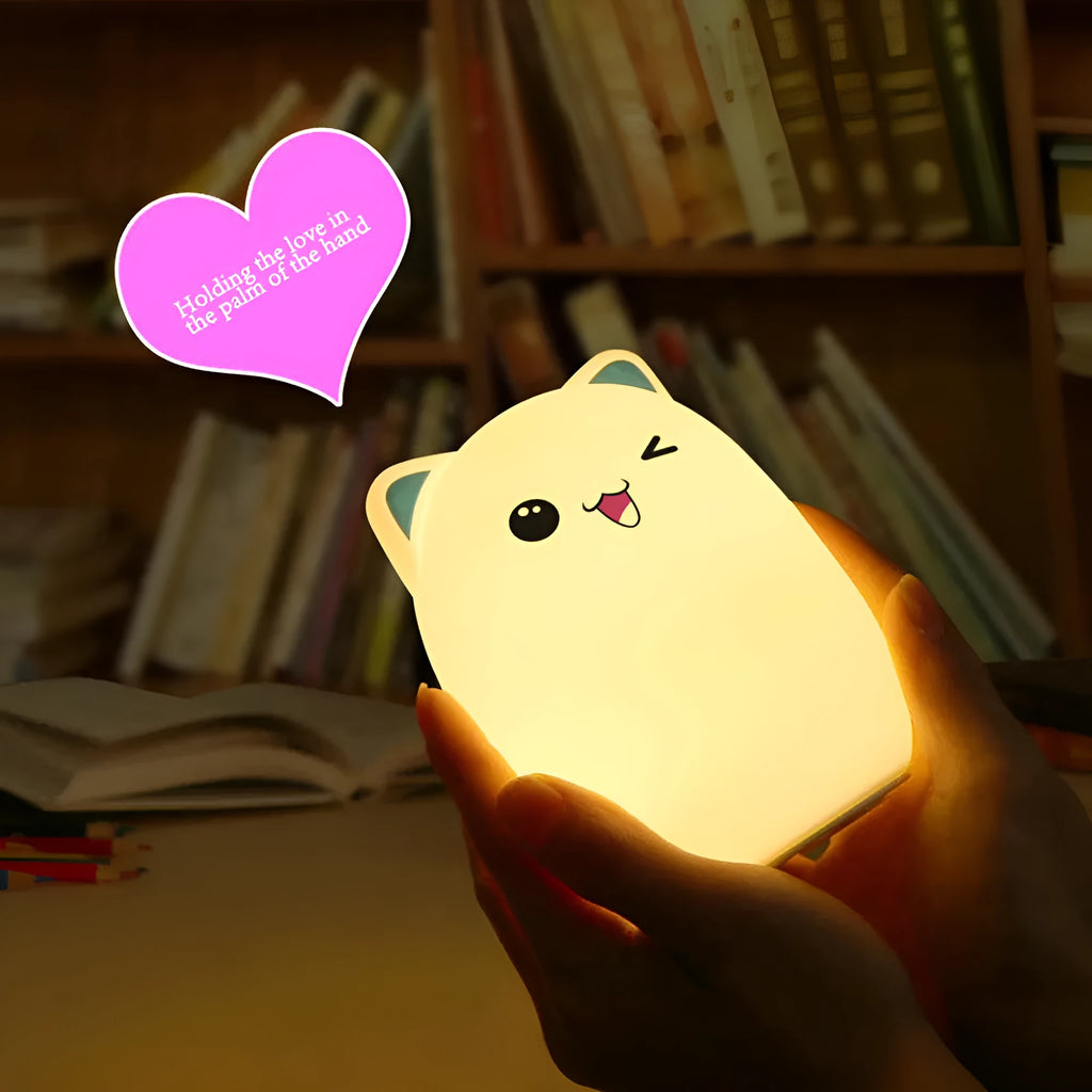 Cartoon silicone clapping lamp in Princess Bear style showing warm white light on a wooden table
