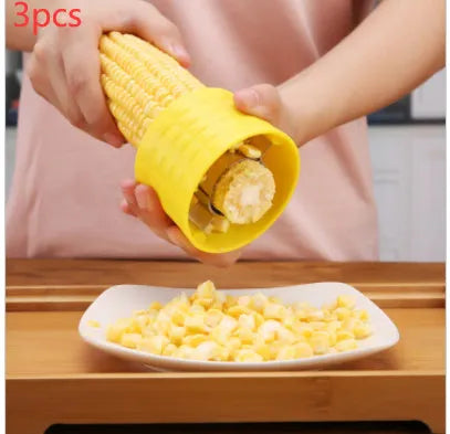 Yellow corn-shaped manual kitchen thresher tool for removing kernels from corn on the cob.