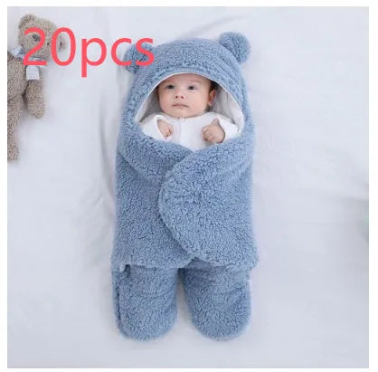 Baby quilted sleeping bag wrapper in a light blue colour showing its quilted pattern and size.