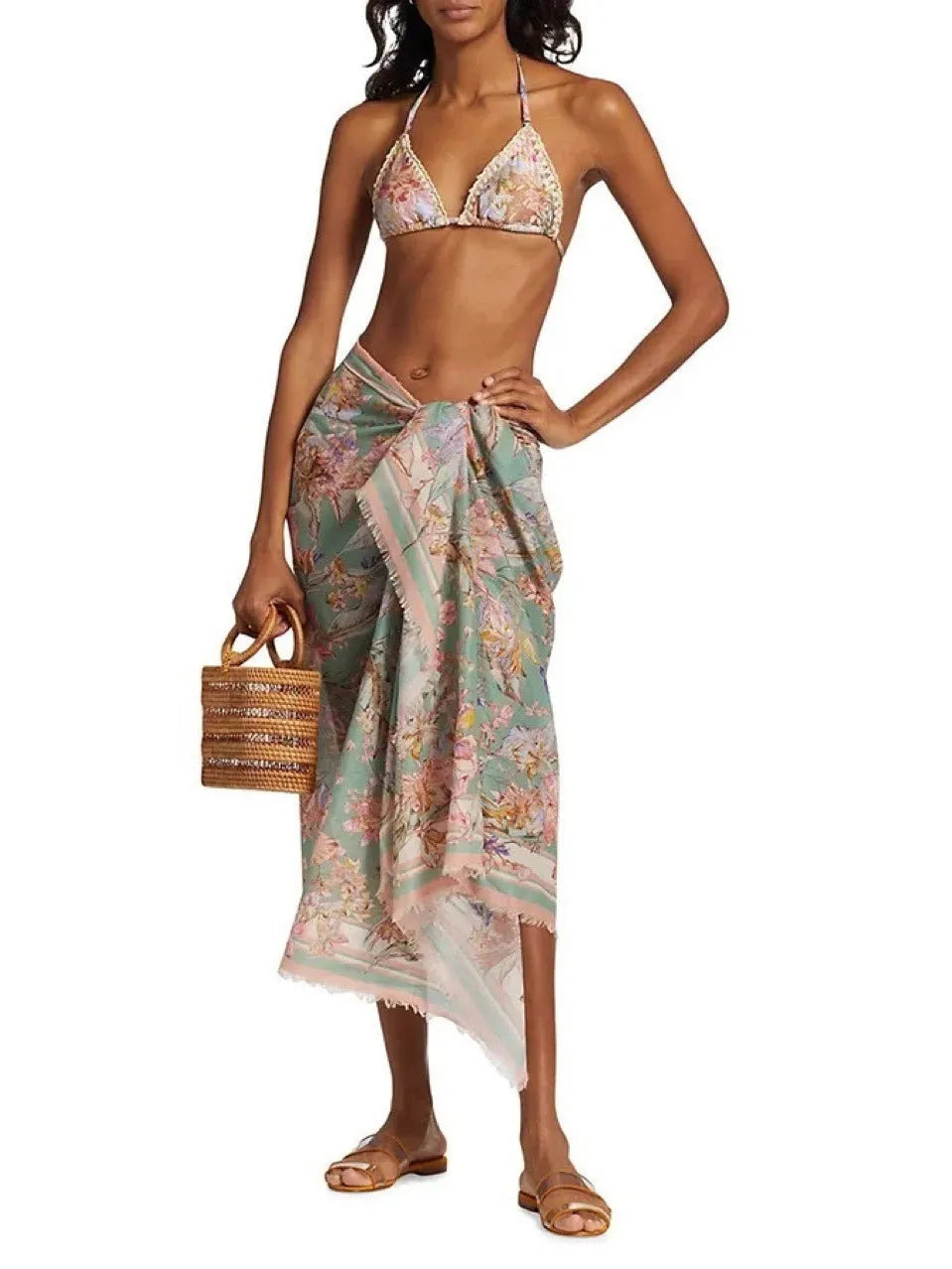 Creamy white floral print women's bikini set with matching skirt on a mannequin.