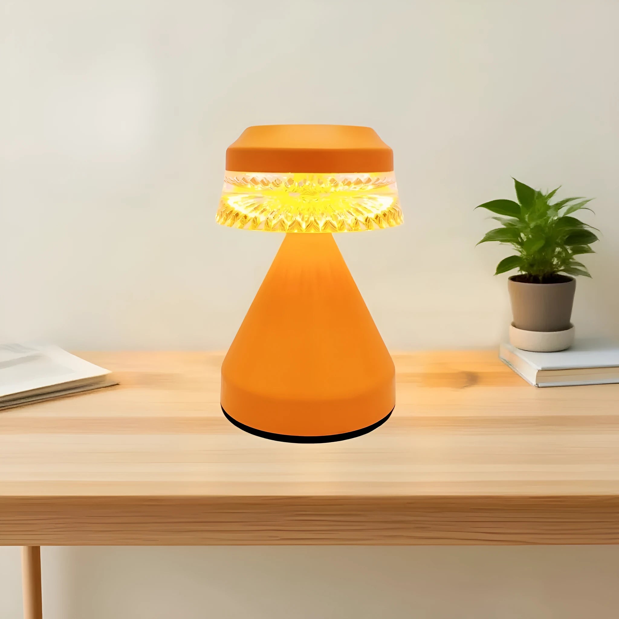 Small modern bedside LED lamp in orange with USB charging cable, showing dimmable light feature.