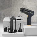 Black wireless handheld car vacuum cleaner with multiple nozzle attachments and USB charging cable