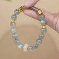 Emerald green jade bangle bracelet with floating flower design and round beads