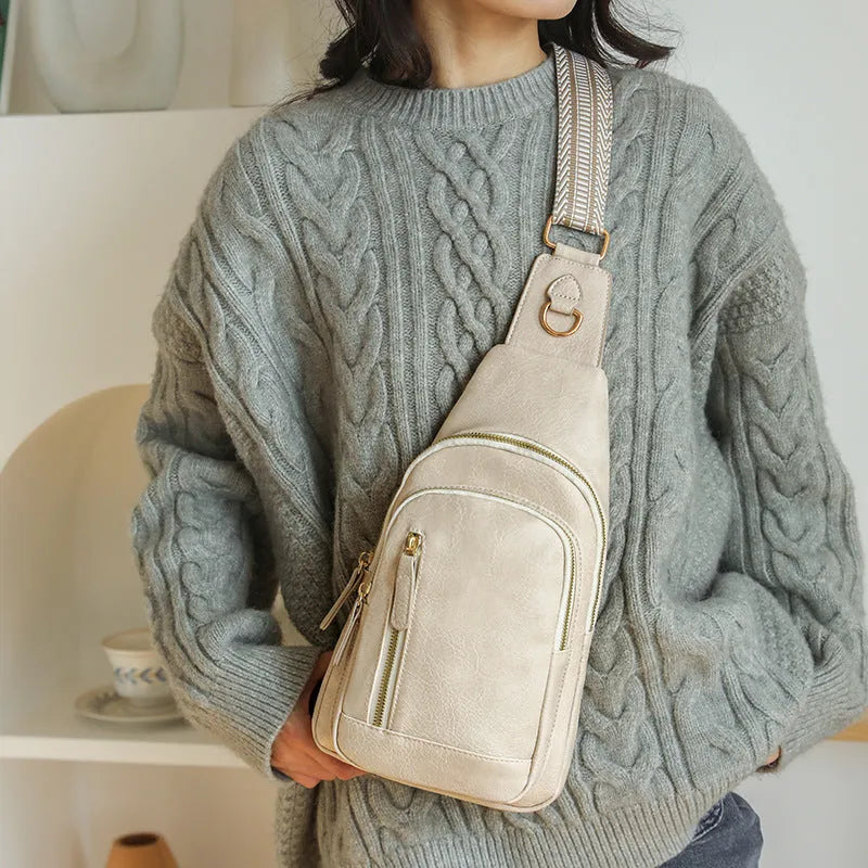 Soft brown PU women's crossbody chest bag with open front pocket and adjustable strap.