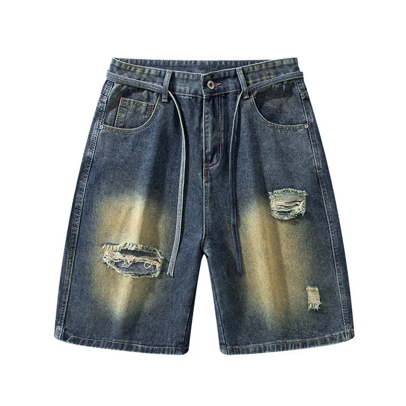 Men's retro blue loose-fit ripped jeans made from cotton denim, shown in a street style.