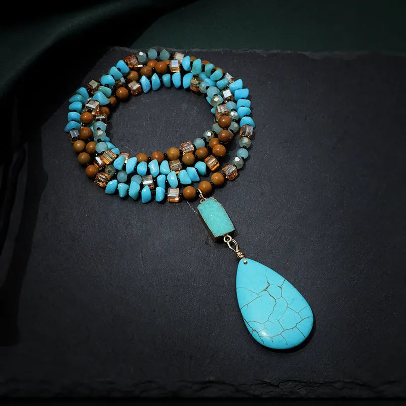 Turquoise blue necklace with water drop shaped pendant on ball bead chain