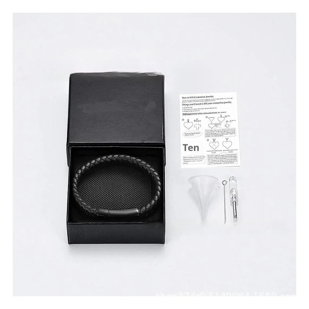 Men's black leather and stainless steel casket bracelet with engraving option on a gift box.