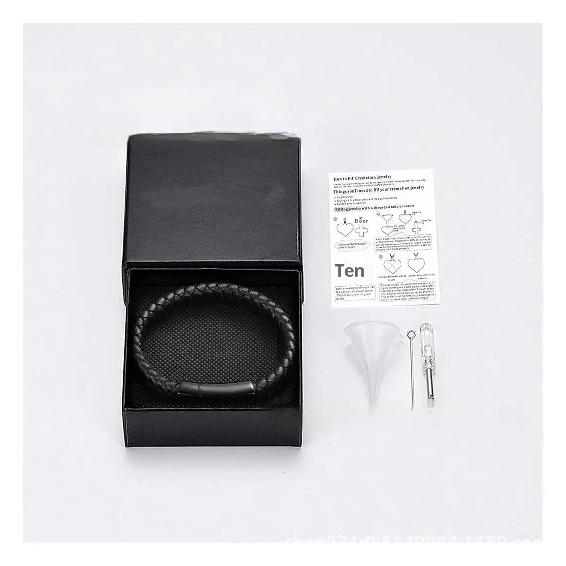 Men's black leather and stainless steel casket bracelet with engraving option on a gift box.
