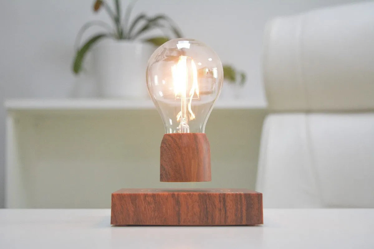 Magnetic levitation floating light bulb hovering above imitation wood base