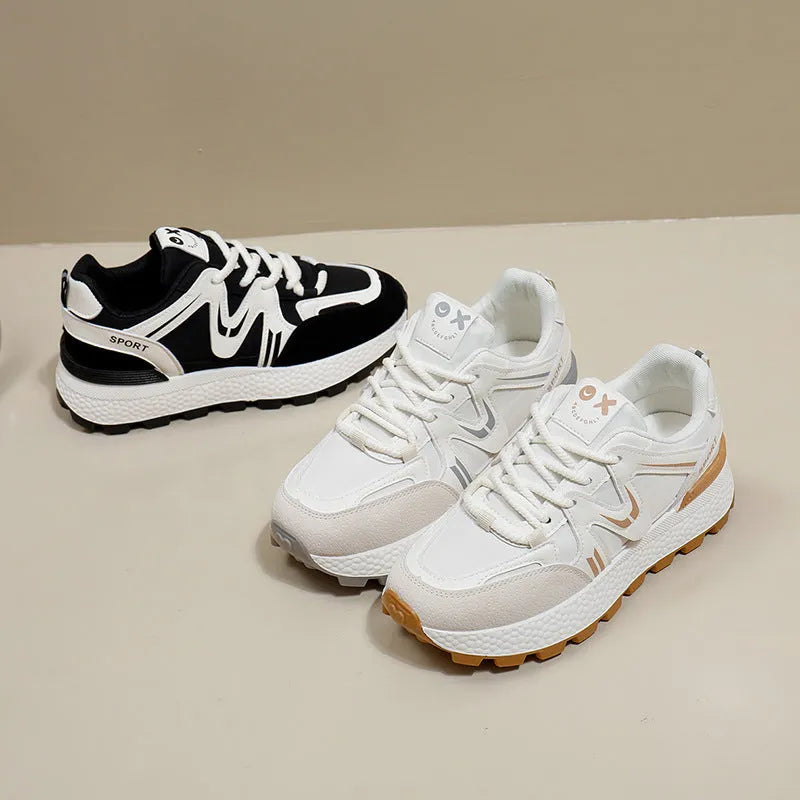 Women's flat-heel casual sports shoes in black with round toe and front lace-up design.