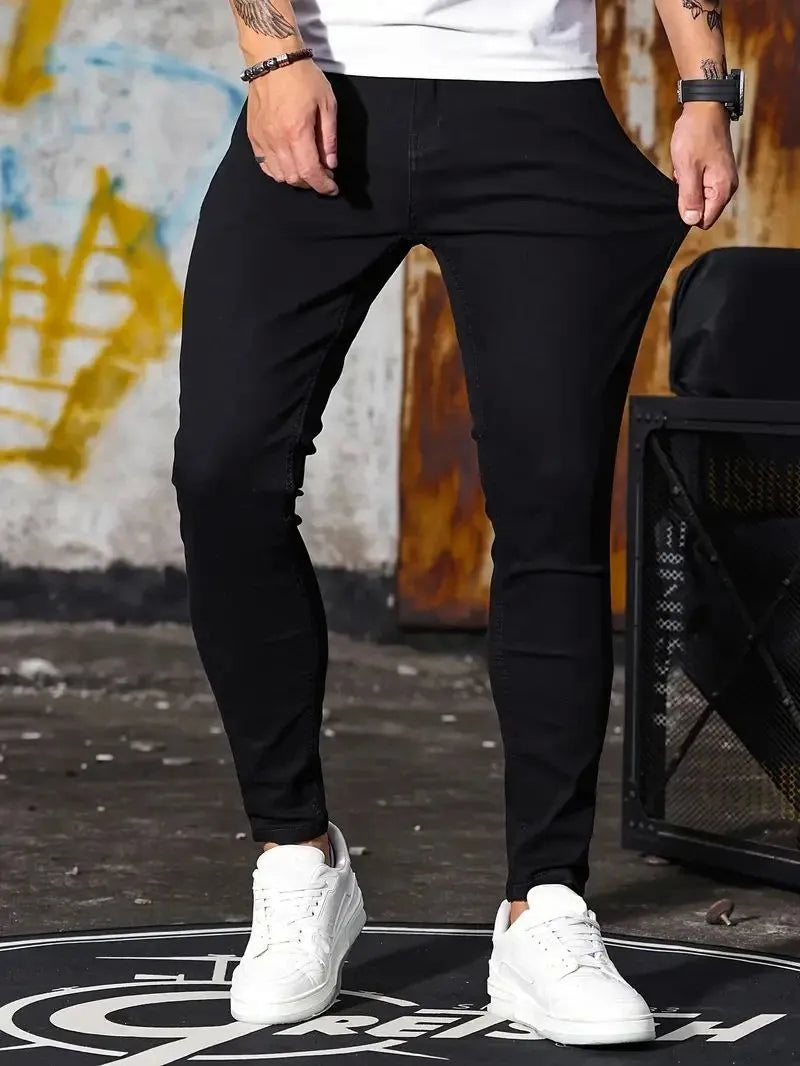 Man wearing retro wash stretch slim fit five-quarter length jeans in blue with zipper and five-pocket design