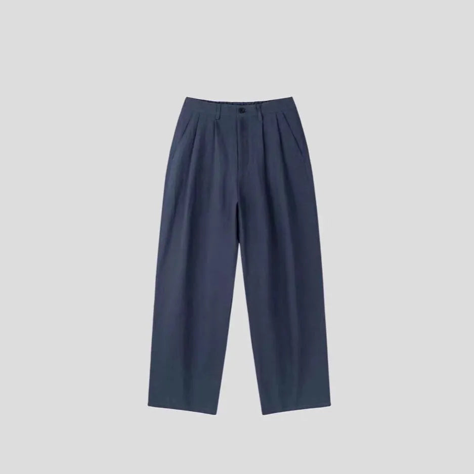 Men's loose-fit apricot cotton linen trousers with wide-leg Korean style on a neutral background.