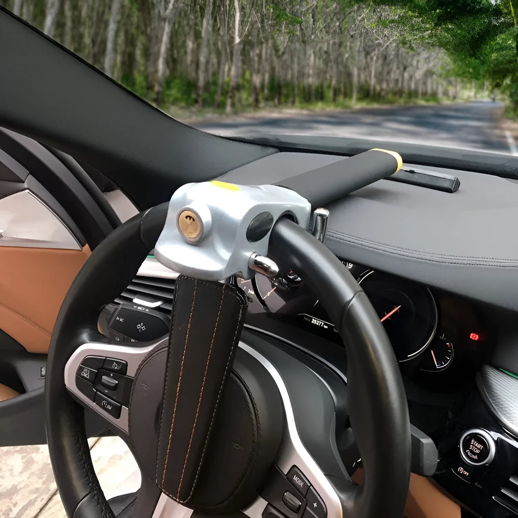 Universal car steering wheel lock with alarm in black gold finish on vehicle steering wheel