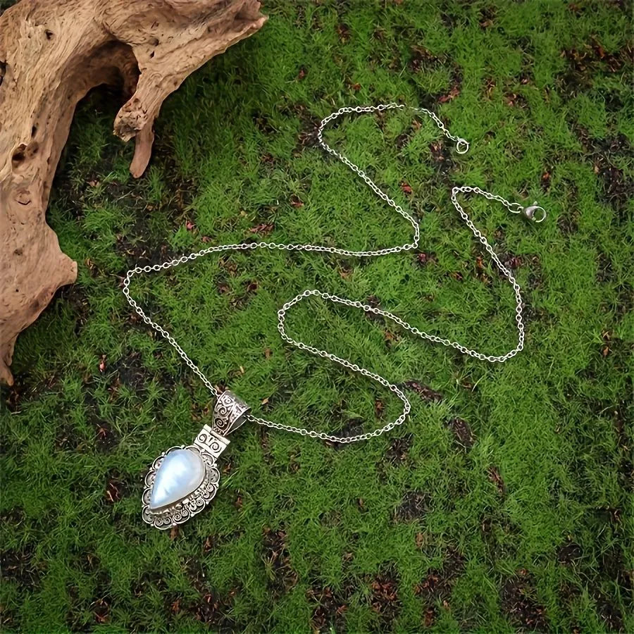 Silver heart-shaped moonstone drop necklace on a white background