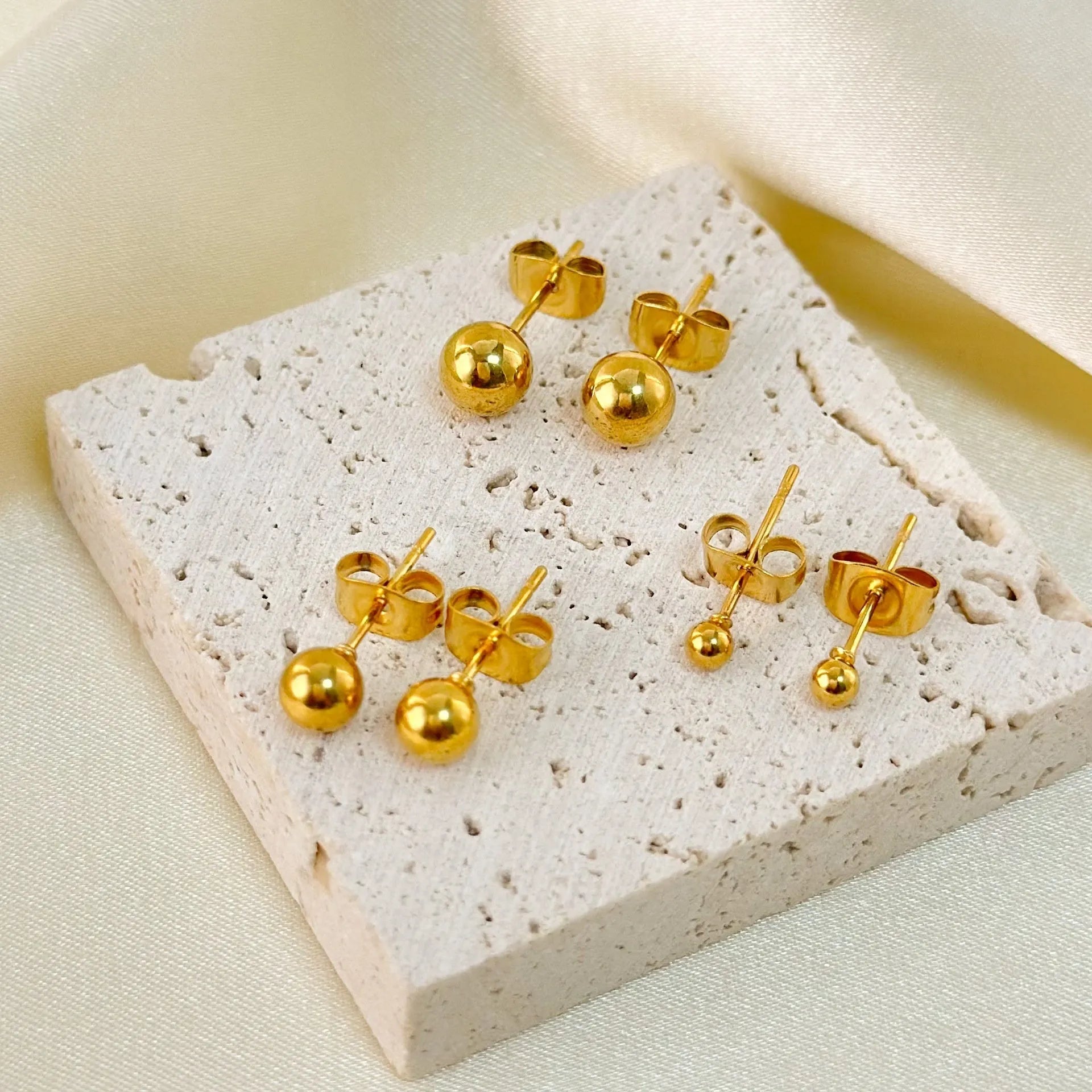 Stainless steel ball stud earrings with gold or silver plating in 3mm, 4mm, 5mm, and 6mm sizes