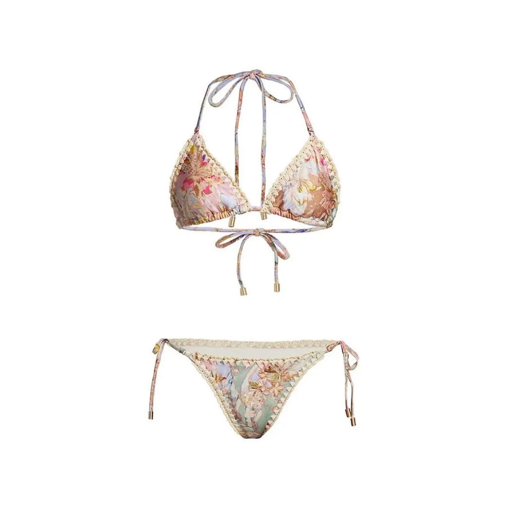 Creamy white floral print women's bikini set with matching skirt on a mannequin.