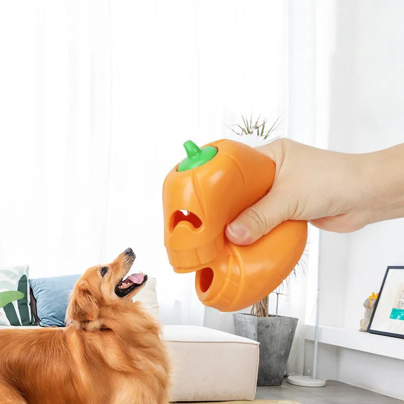 Halloween pumpkin shaped orange dog chew toy with treat-dispensing funnel opening