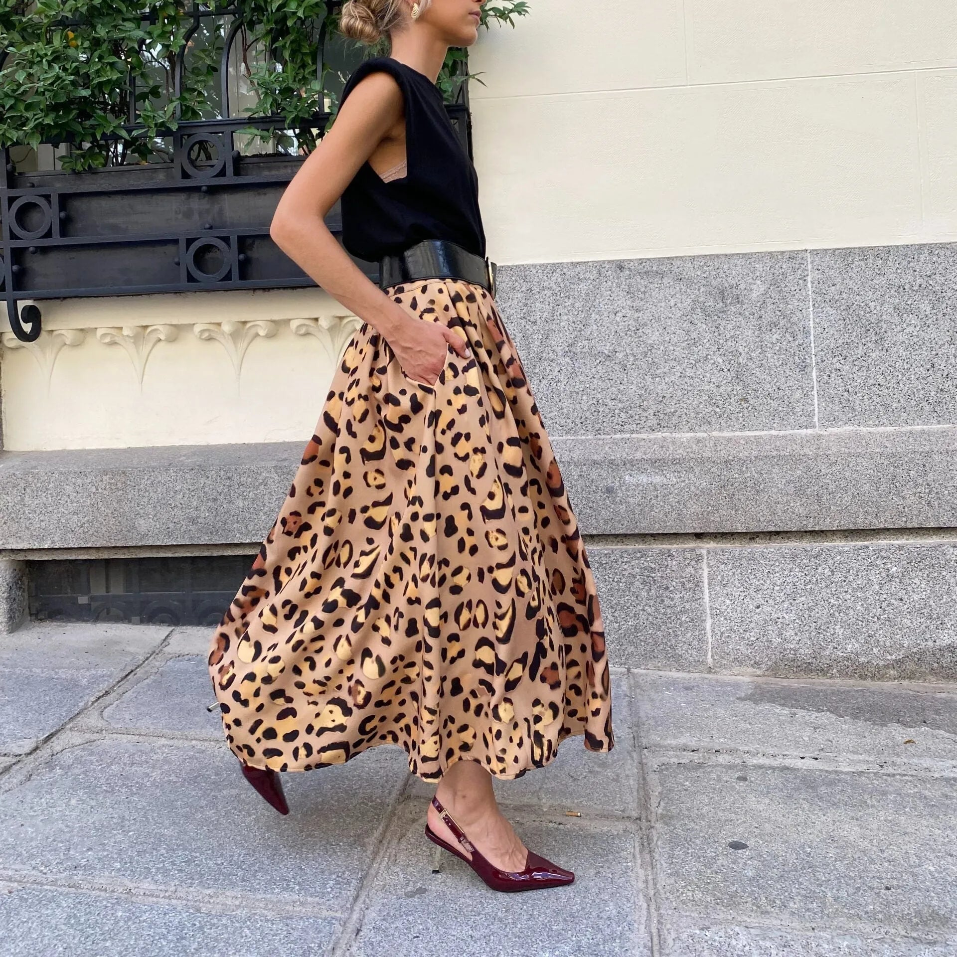 Brown leopard print women's A-line long skirt with big hem design on mannequin