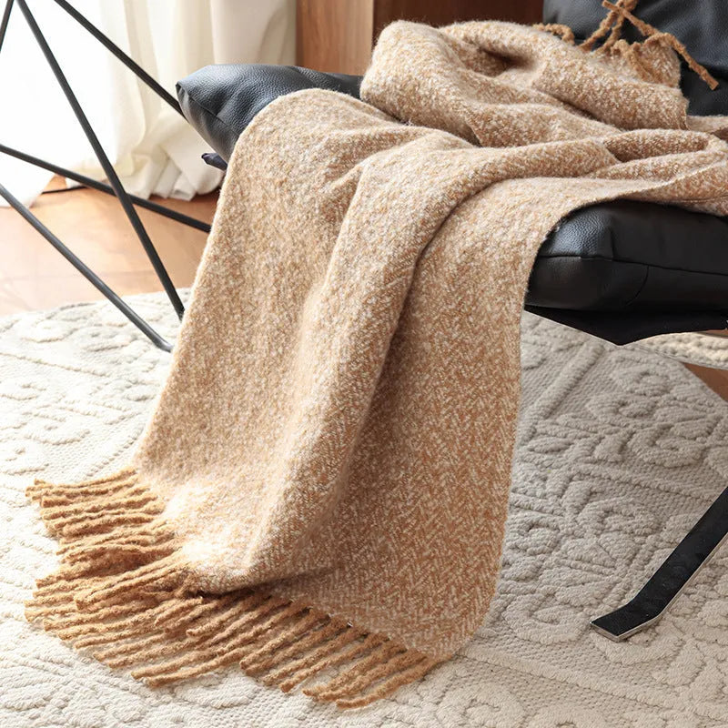 Navy blue polyester fibre leisure blanket folded on a simple sofa