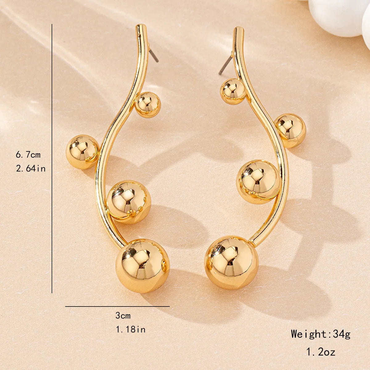 Golden yellow iron ball stud earrings with round shape on a white background