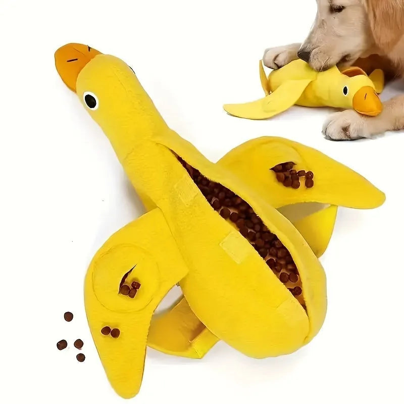 Yellow plush duck dog toy with squeaker and treat-dispensing feature for training and play.