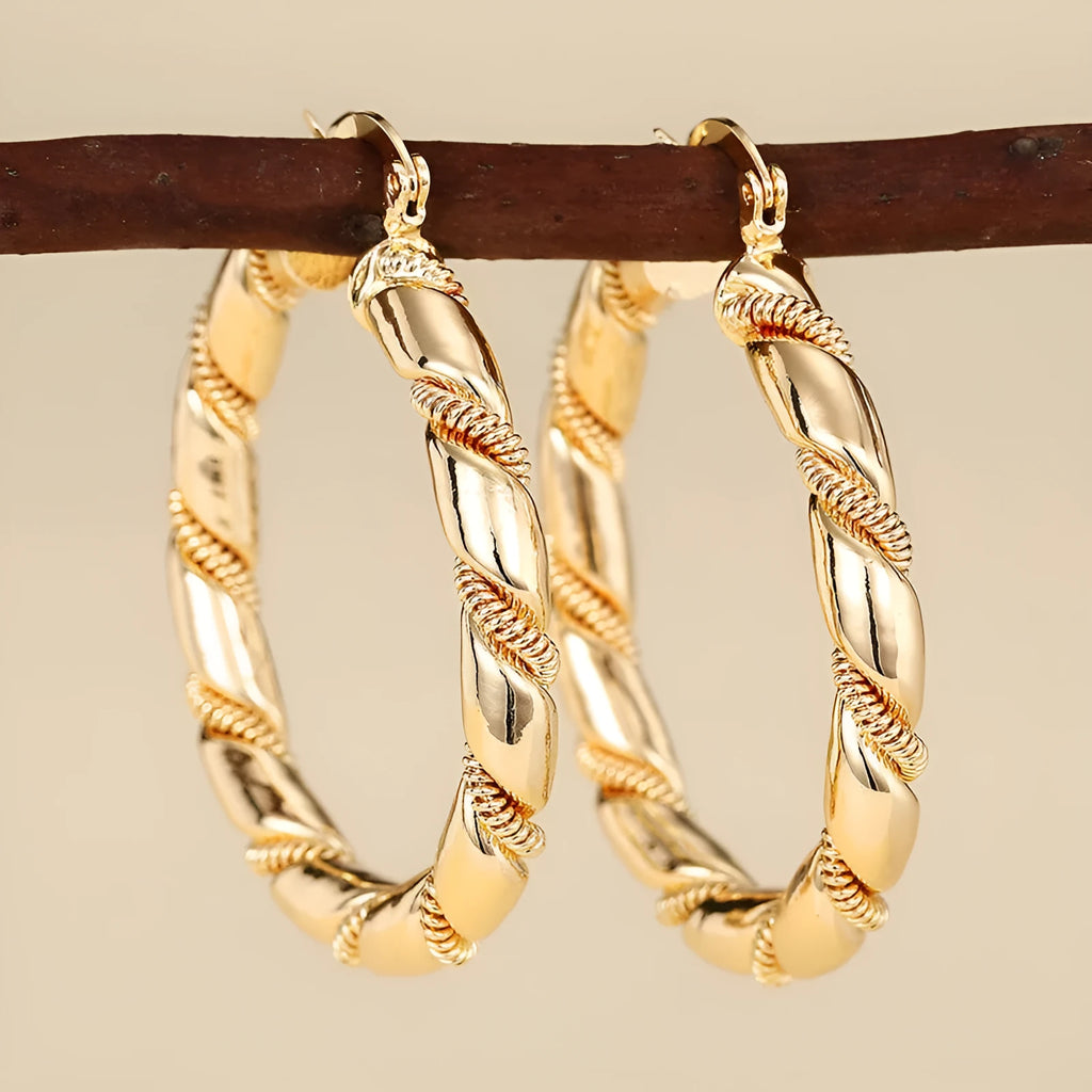 Women's geometric copper earrings with ring and line design elements in golden colours