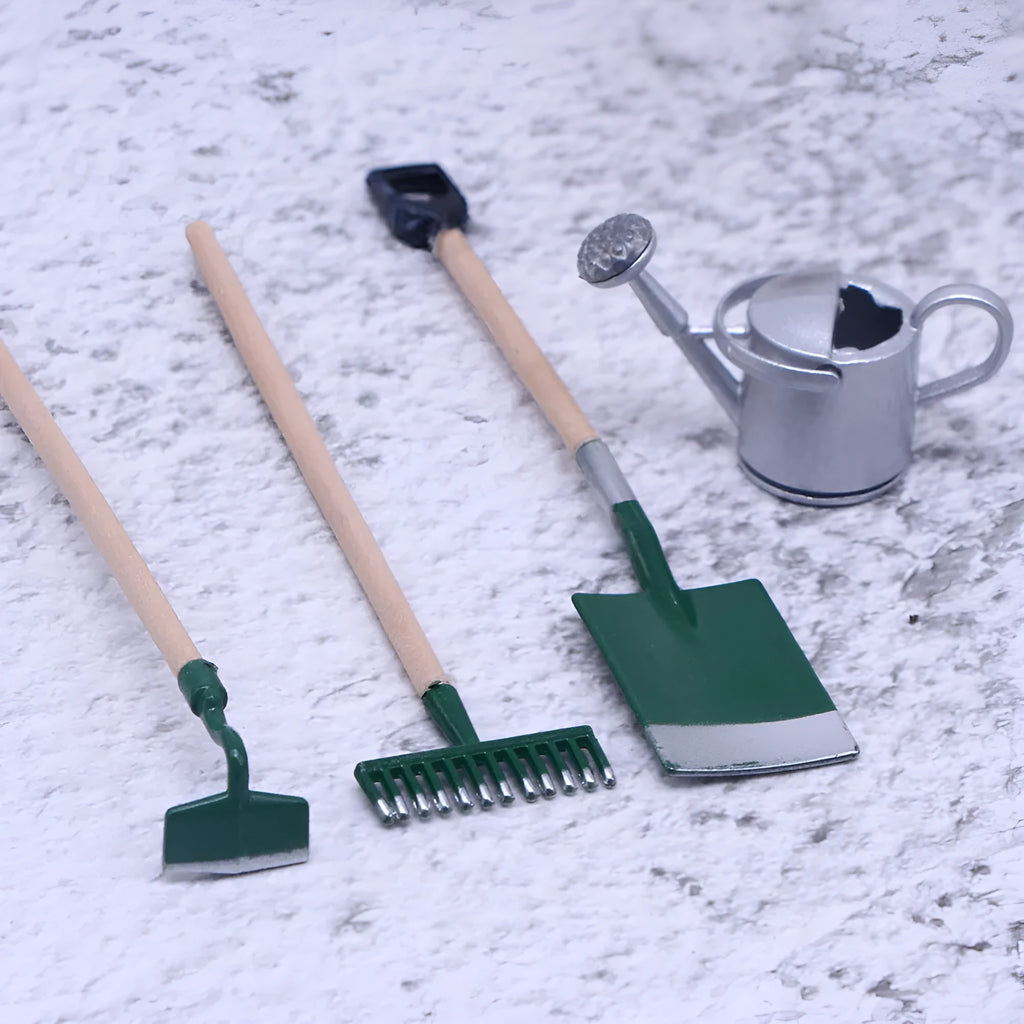 Three miniature alloy gardening tools set for dollhouse or elf garden scenes on white background