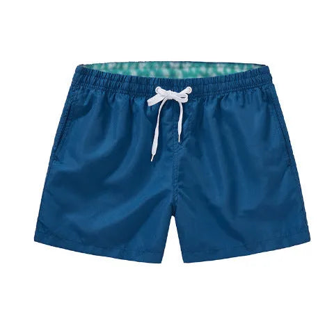 Men's black polyester beach shorts with a straight leg, shown on a size chart with options up to 4XL.
