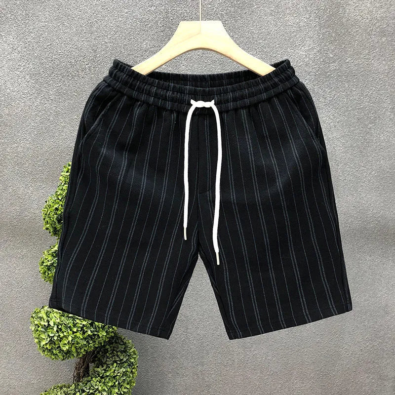 Man wearing black and white striped fleece-lined casual shorts with an elasticated waistband.
