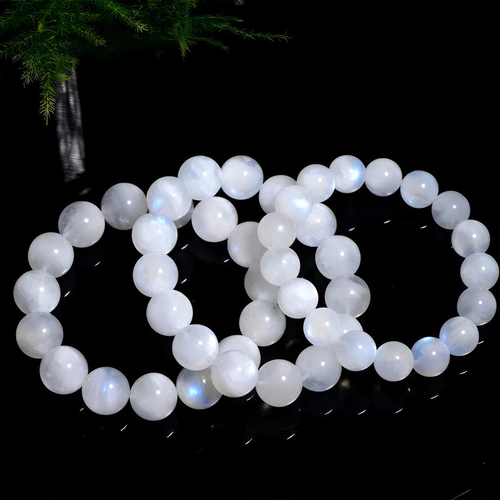 Natural blue moonlight round bead moonstone bracelet showing polished gemstone beads on wrist