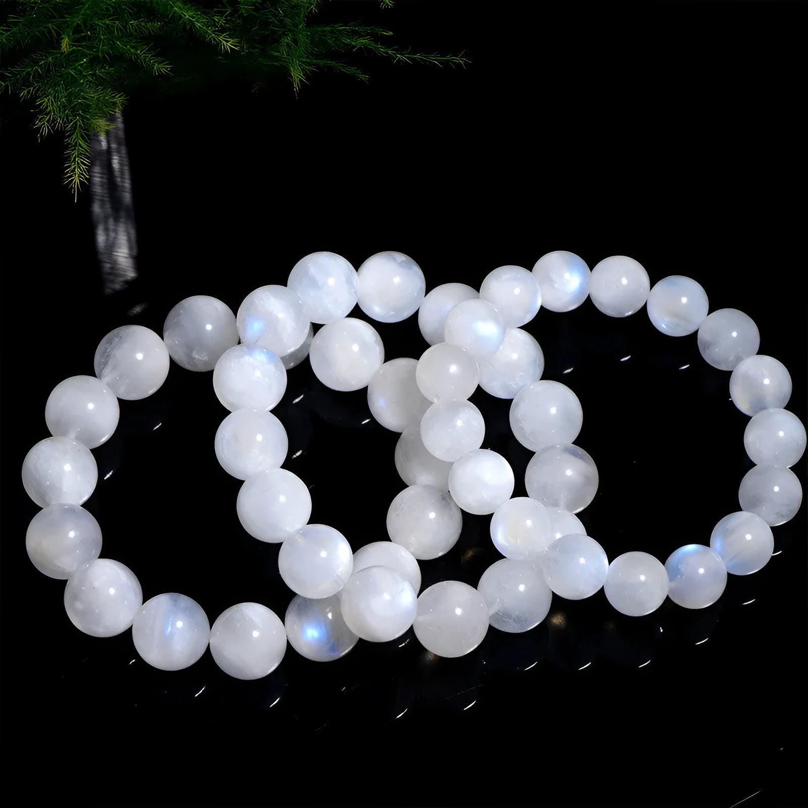 Natural blue moonlight round bead moonstone bracelet showing polished gemstone beads on wrist