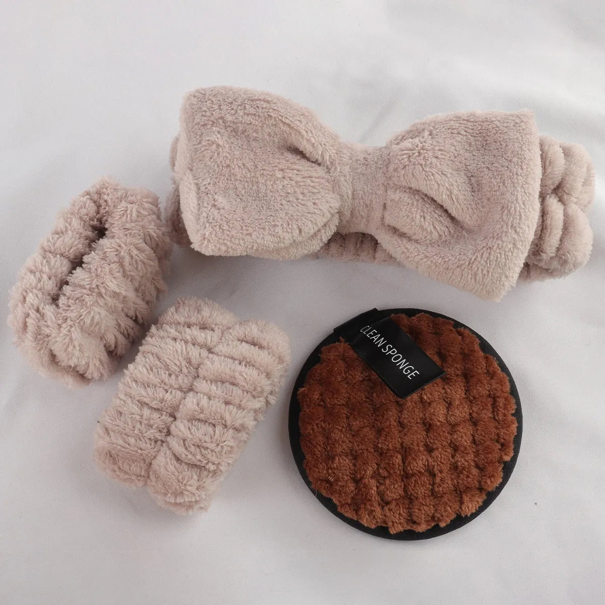 40-piece makeup sponge set in coffee brown, pink, and purple on white background