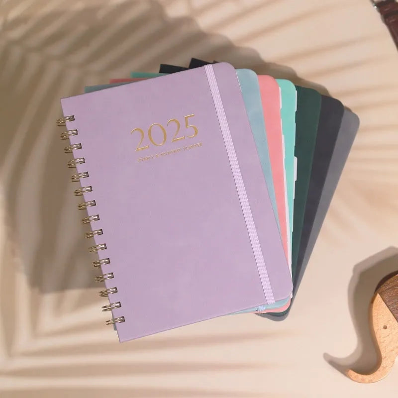 A5 size PU leather notebook with metal coil binding in various colour options showing year-specific cover designs