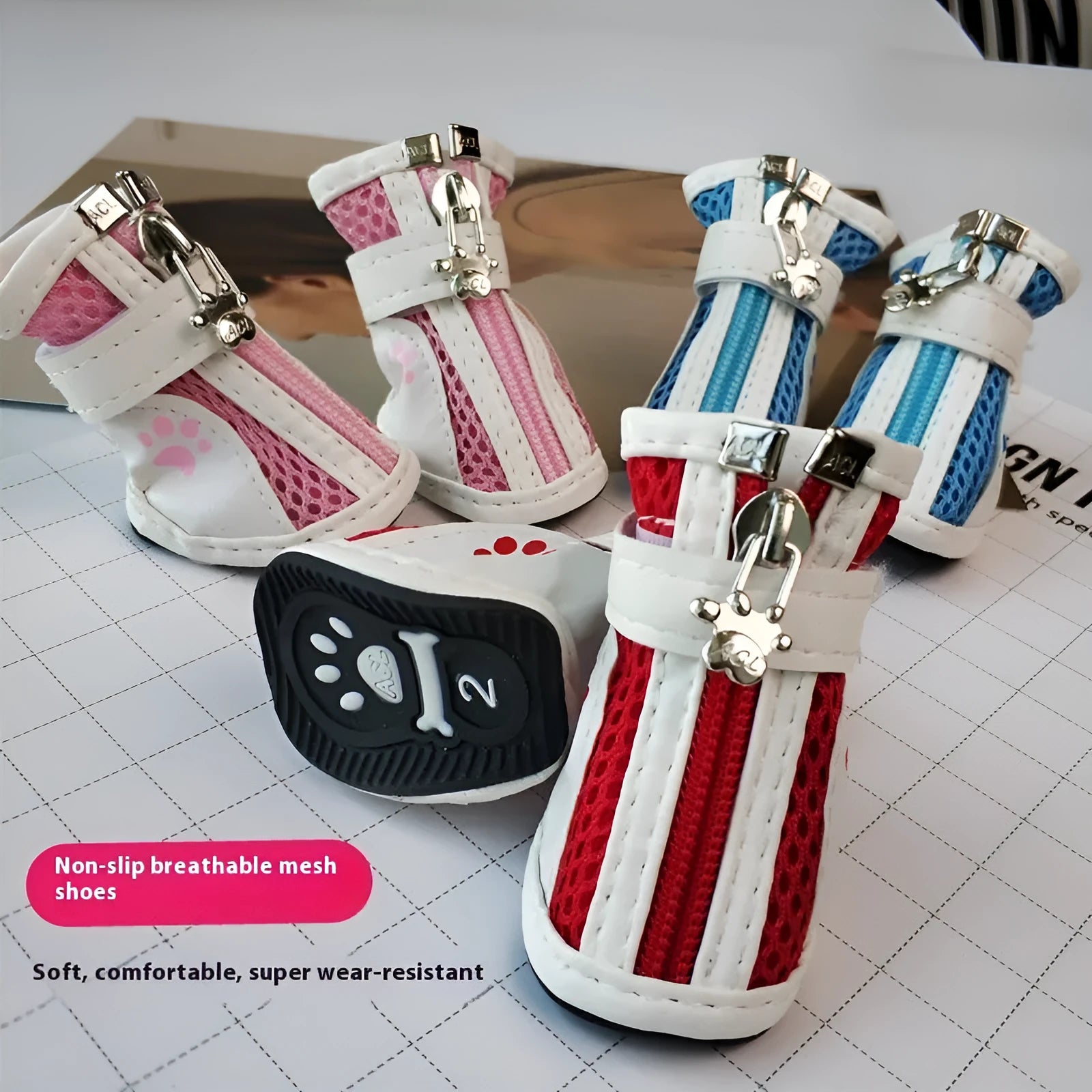 Set of four blue cloth dog shoes with side zips for small breed pets.